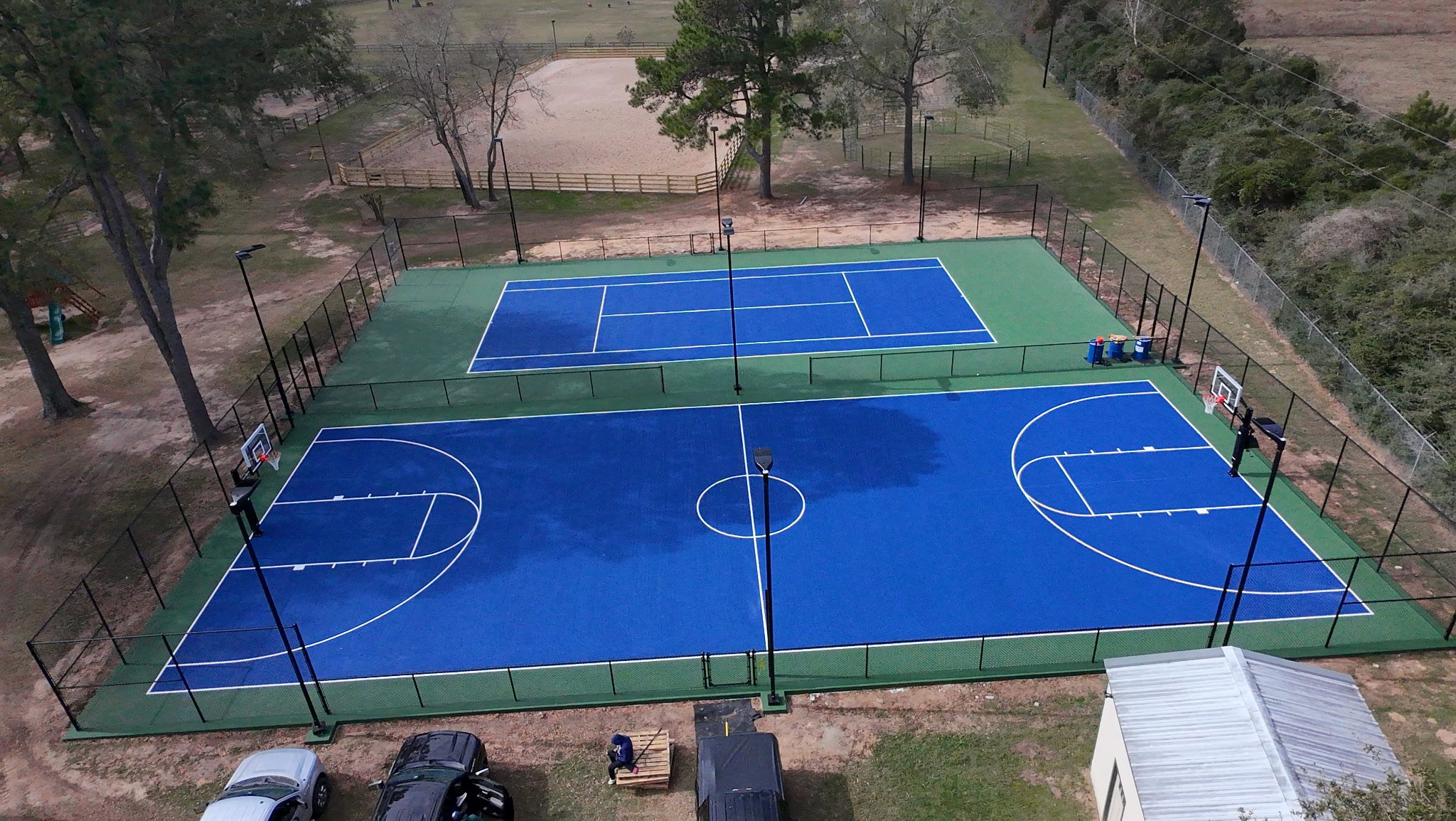 Professional court maintenance team cleaning and inspecting surface